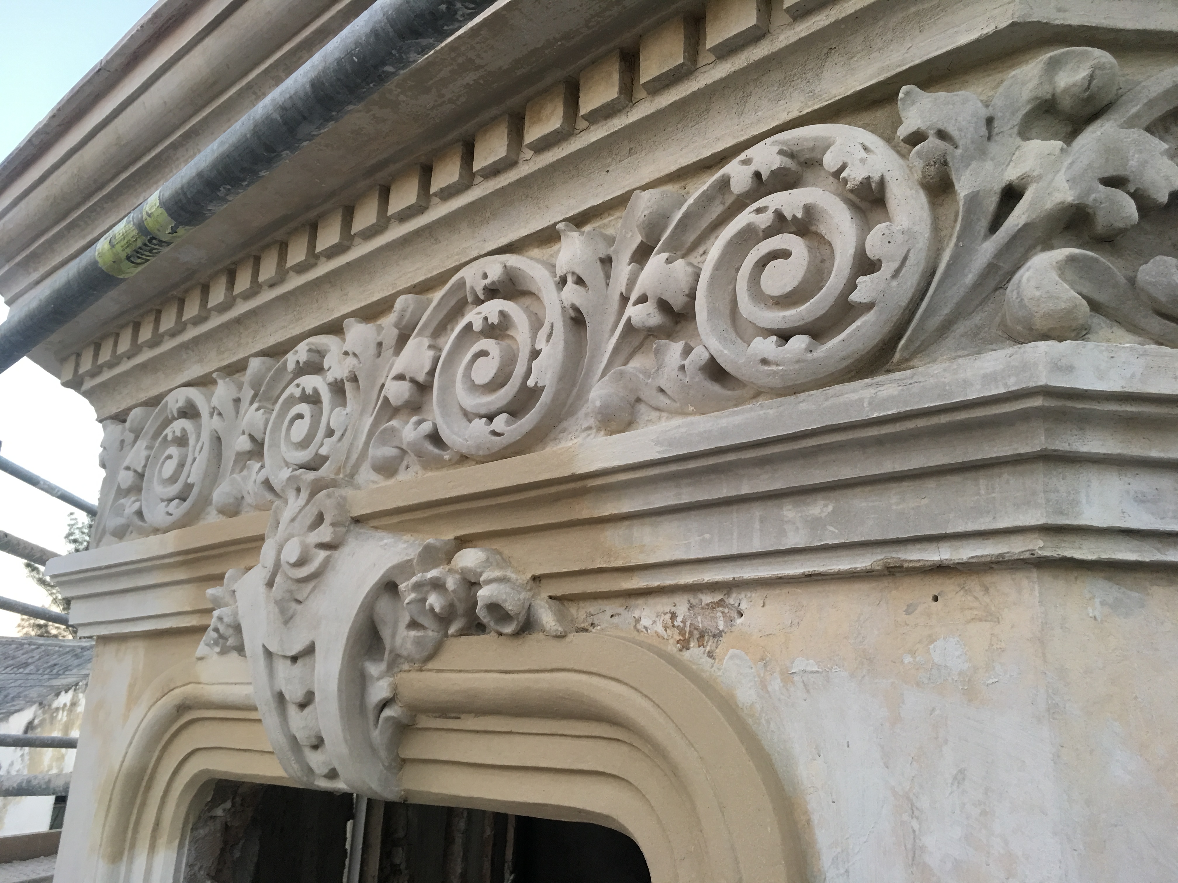 Restored ornamental scrollwork above a doorway